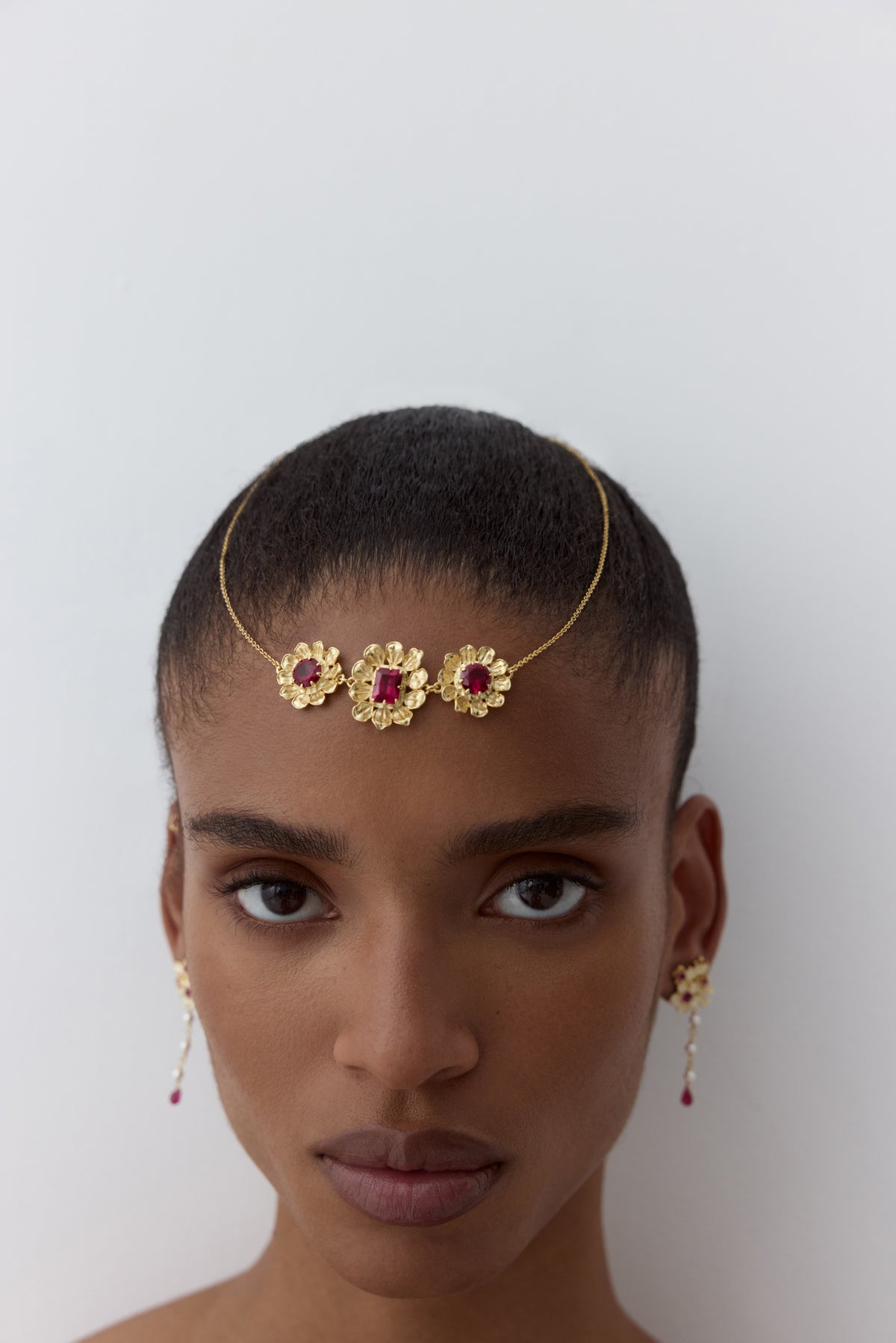 Gold anemone statement necklace with pink stones